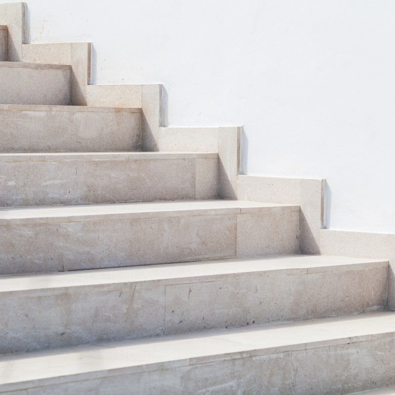Empty stone stairway near white wall, abstract photo